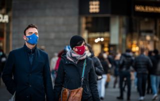 Masked Couple holding hands on street