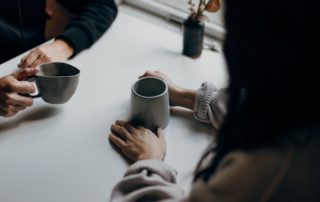 Two people drinking coffee