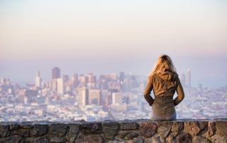 Woman sitting looking at skyline