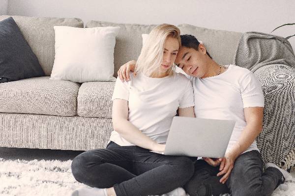 Couple on floor with computer