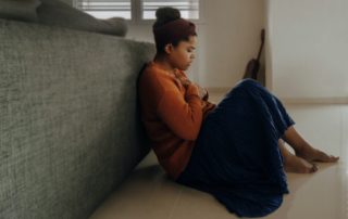 Anxious woman sitting on floor